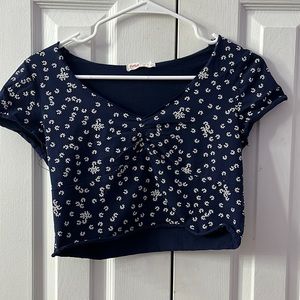 Medium (size 6) blue cropped shirt with white flower prints. ROMWE